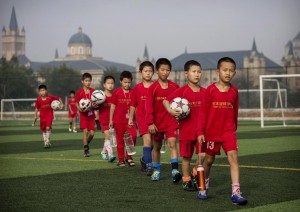 Young boys prepare for football training outside their football school