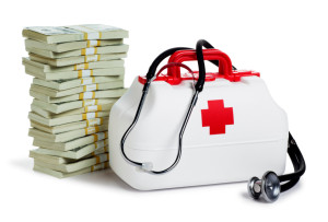 Stacks of money with a medical kit