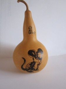 A front on view of a painted gourd with a rat image and Chinese character
