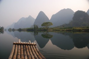 Traveling by boat along China river with mountains