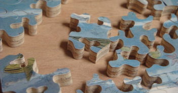 The Many Meanings of the Word Yi Si jigsaw pieces spread out on a table