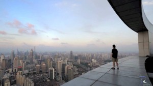 man standing on a ledge overlooking the city china