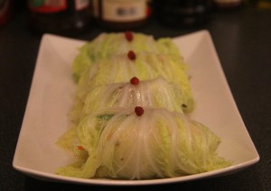 cabbage vegetable rolls on a white plate