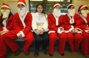 people in china dressed as santa on metro