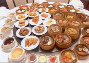 a large selection of dishes served on a round table