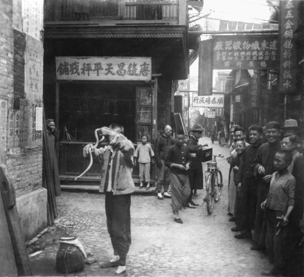 A snake charmer on the streets of Shanghai, late 1920s