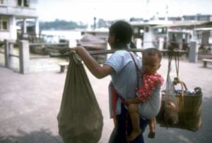 A mother carrying her child and food shopping in 1978 - The Chairman's Bao