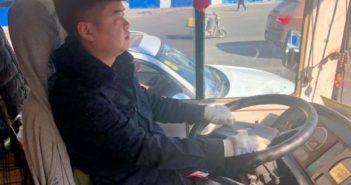 长春一个公交车司机用双语报站 side view of bus driver behind the wheel in changchun