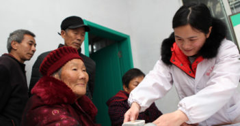 中国老人对护士需求增加 nurse taking elderly woman's blood pressure