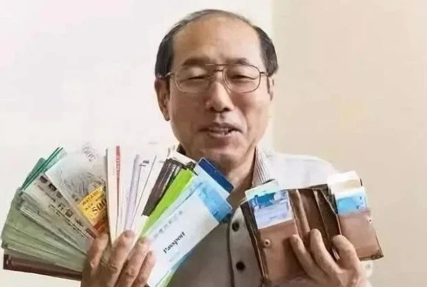 man posing with wallet and coupons in japan