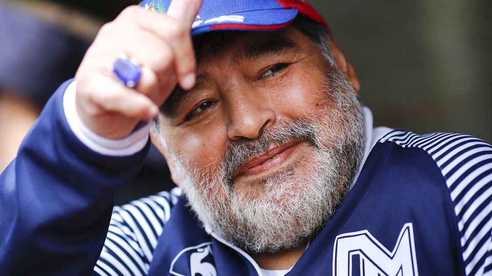 diego maradona posing for a picture