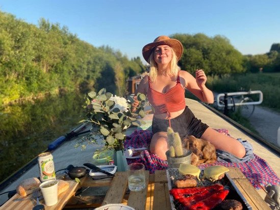 woman having picnic on boat in UK