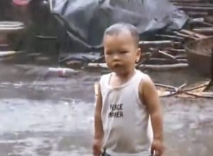 Netizens Impressed With Young Boy's Stubbornness In the Rain